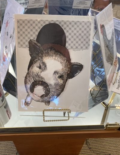 A display case showcasing a picture of a pig, adding a touch of charm and whimsy to the surroundings.