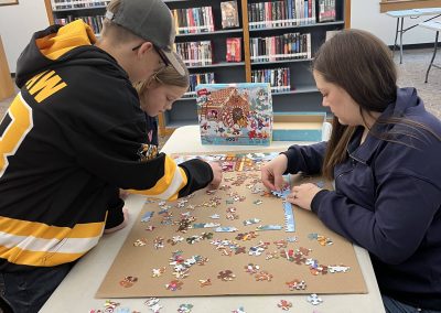 A family collaborating on a colorful puzzle, sharing smiles and teamwork as they piece it together.